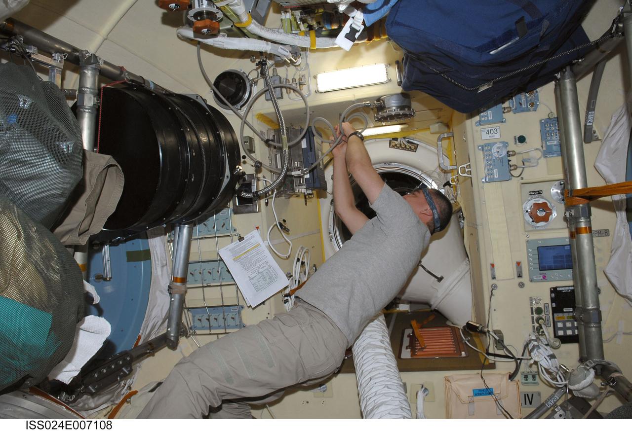 ISS024-E-007108 (30 June 2010) --- Russian cosmonaut Alexander Skvortsov, Expedition 24 commander, installs hardware for the new Plasma Crystal-3 Plus experiment in the Poisk Mini-Research Module 2 (MRM2) of the International Space Station.