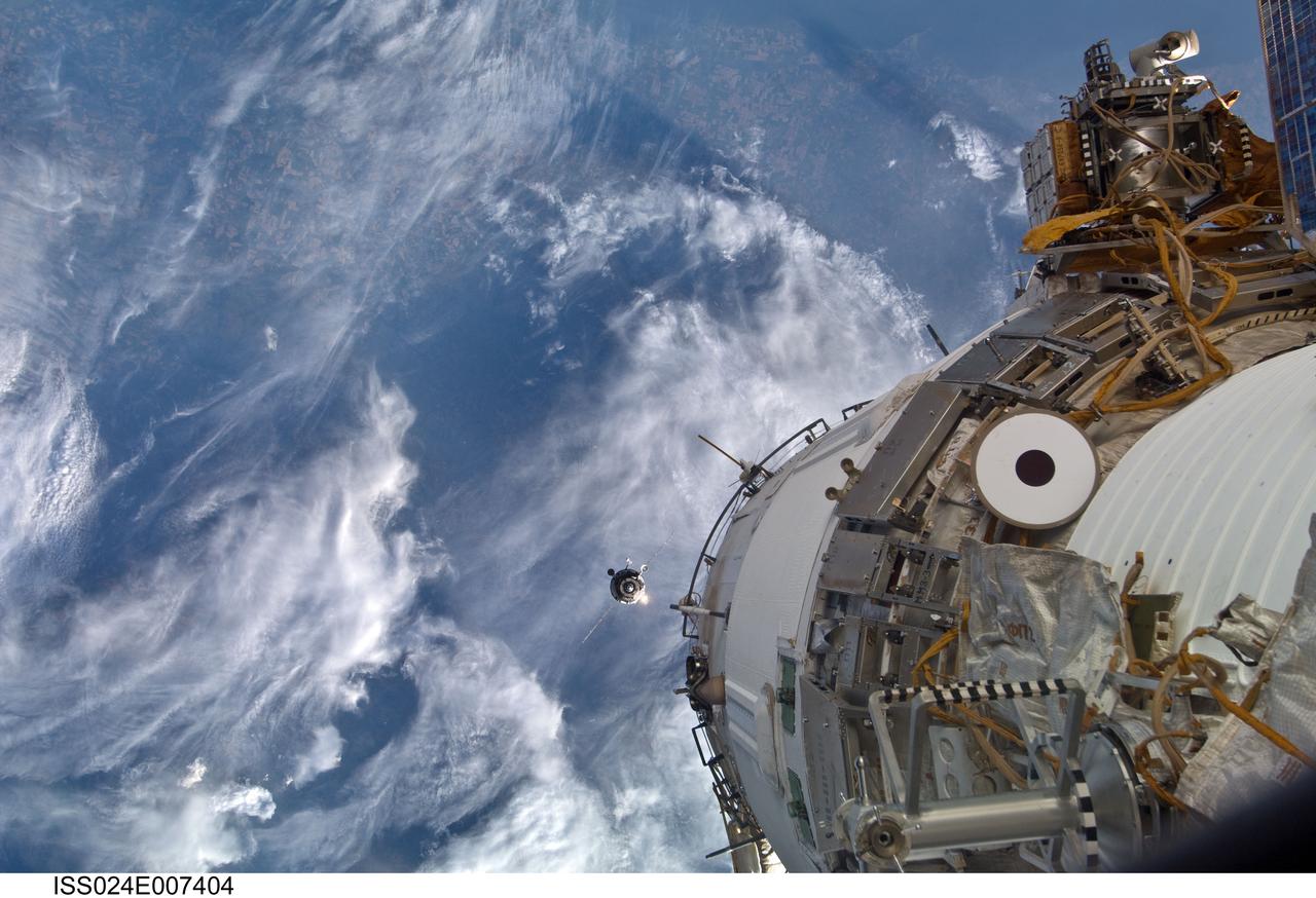 ISS024-E-007404 (4 July 2010) --- An unpiloted ISS Progress resupply vehicle approaches the International Space Station, bringing almost two tons of food, fuel, oxygen, propellant and supplies for the Expedition 24 crew members aboard the station. After an aborted docking on July 2, Progress 38 successfully docked to the aft end of the Zvezda Service Module at 12:17 p.m. (EDT) on July 4, 2010. The docking was executed flawlessly by Progress’ Kurs automated rendezvous system.