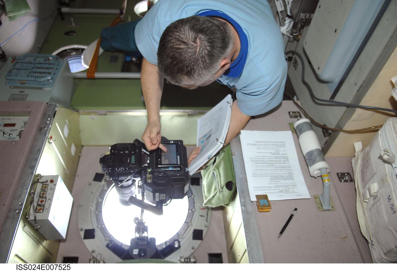 ISS024-E-007525 (8 July 2010) --- In the International Space Station’s Zvezda Service Module, Russian cosmonaut Fyodor Yurchikhin, Expedition 24 flight engineer, conducts a session for Russia's Environmental Safety Agency (EKON), making observations and taking KPT-3 aerial photography of environmental conditions on Earth.