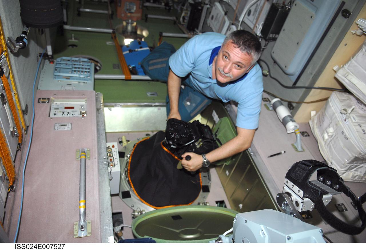 ISS024-E-007527 (8 July 2010) --- In the International Space Station’s Zvezda Service Module, Russian cosmonaut Fyodor Yurchikhin, Expedition 24 flight engineer, conducts a session for Russia's Environmental Safety Agency (EKON), making observations and taking KPT-3 aerial photography of environmental conditions on Earth.