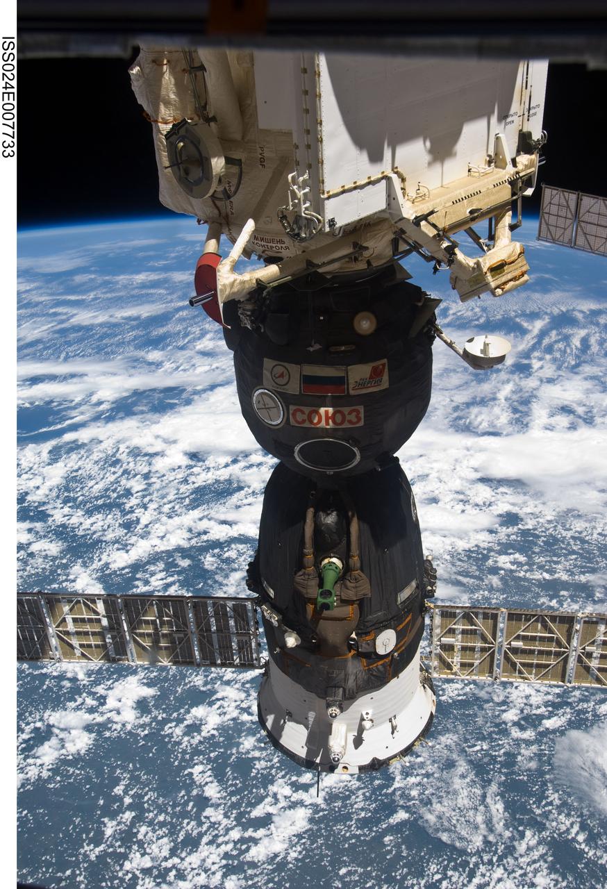 ISS024-E-007733 (9 July 2010) --- The Soyuz TMA-19 spacecraft, docked to the Rassvet Mini-Research Module 1 (MRM1), is featured in this image photographed by an Expedition 24 crew member on the International Space Station. A blue and white part of Earth and the blackness of space provide the backdrop for the scene.