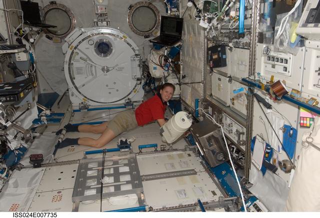 NASA image: Shannon Walker cleans the JPM