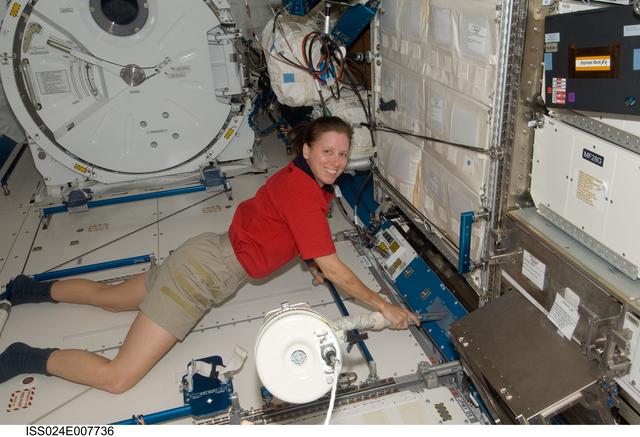 NASA image: Shannon Walker cleans the JPM