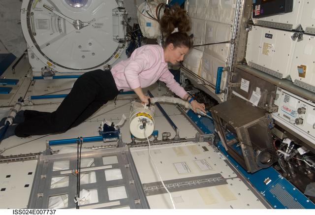 NASA image: Tracy Caldwell Dyson cleans the JPM
