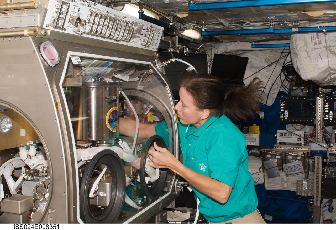 ISS024-E-008351 (15 July 2010) --- NASA astronaut Shannon Walker, Expedition 24 flight engineer, works with the Smoke Aerosol Measurement Experiment (SAME) in the Microgravity Sciences Glovebox (MSG) located in the Columbus laboratory of the International Space Station.