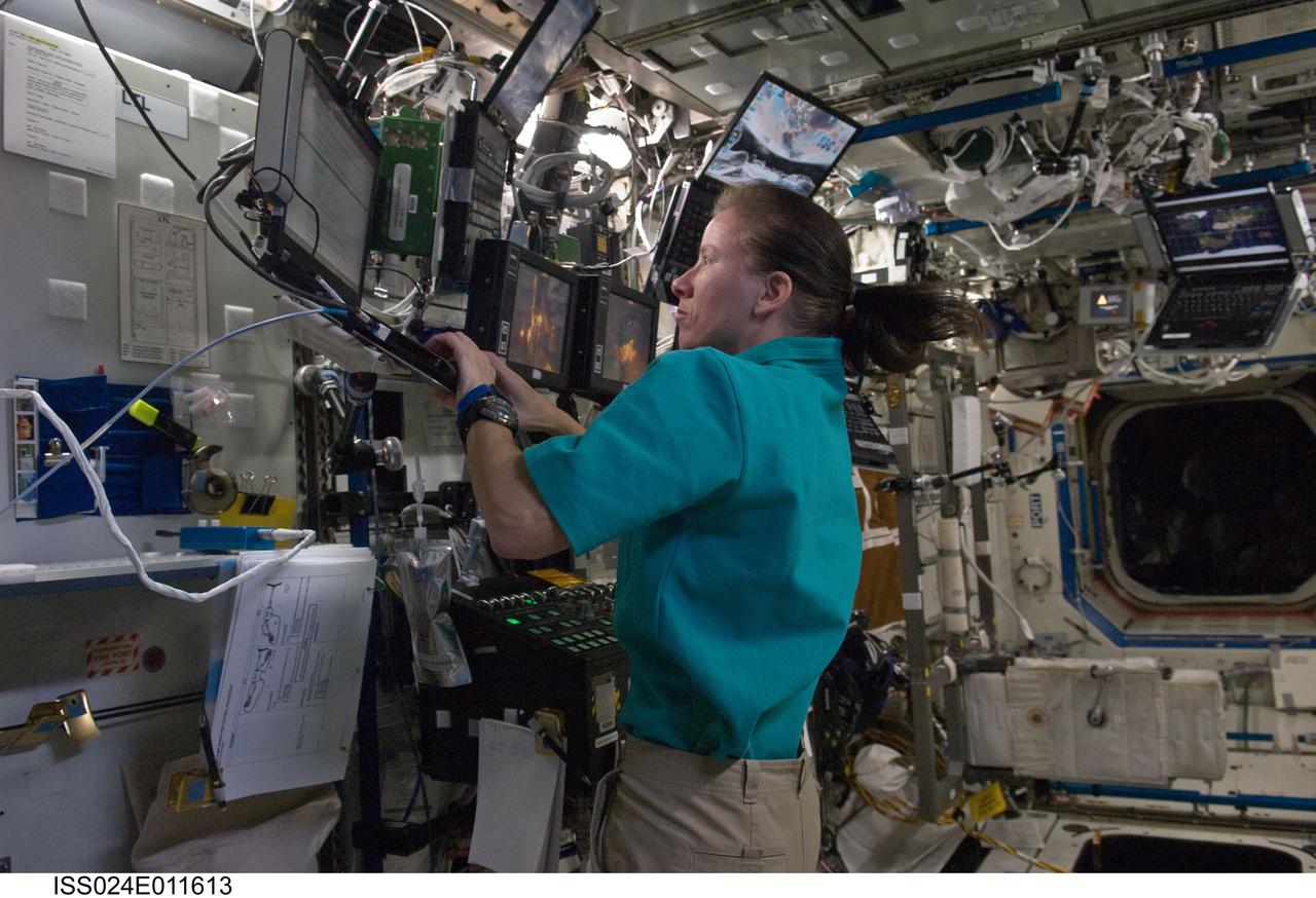 ISS024-E-011613 (7 Aug. 2010) --- NASA astronaut Shannon Walker, Expedition 24 flight engineer, uses a computer near a robotic workstation in the Destiny laboratory of the International Space Station.