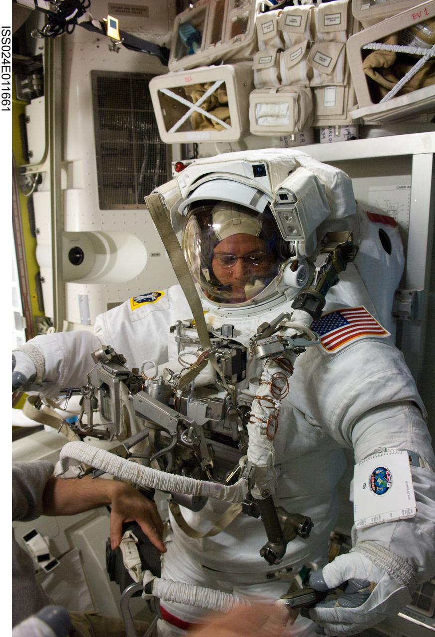 ISS024-E-011661 (11 Aug. 2010) --- NASA astronaut Doug Wheelock, Expedition 24 flight engineer, attired in his Extravehicular Mobility Unit (EMU) spacesuit, is pictured in the Quest airlock of the International Space Station during preparations for the second of three planned spacewalks to remove and replace an ammonia pump module that failed July 31.