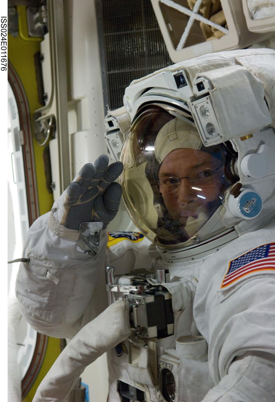 ISS024-E-011676 (11 Aug. 2010) --- NASA astronaut Doug Wheelock, Expedition 24 flight engineer, attired in his Extravehicular Mobility Unit (EMU) spacesuit, is pictured in the Quest airlock of the International Space Station as the second of three planned spacewalks to remove and replace an ammonia pump module that failed July 31 draws to a close.