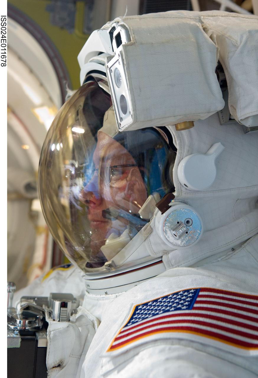 ISS024-E-011678 (11 Aug. 2010) --- NASA astronaut Doug Wheelock, Expedition 24 flight engineer, attired in his Extravehicular Mobility Unit (EMU) spacesuit, is pictured in the Quest airlock of the International Space Station as the second of three planned spacewalks to remove and replace an ammonia pump module that failed July 31 draws to a close.