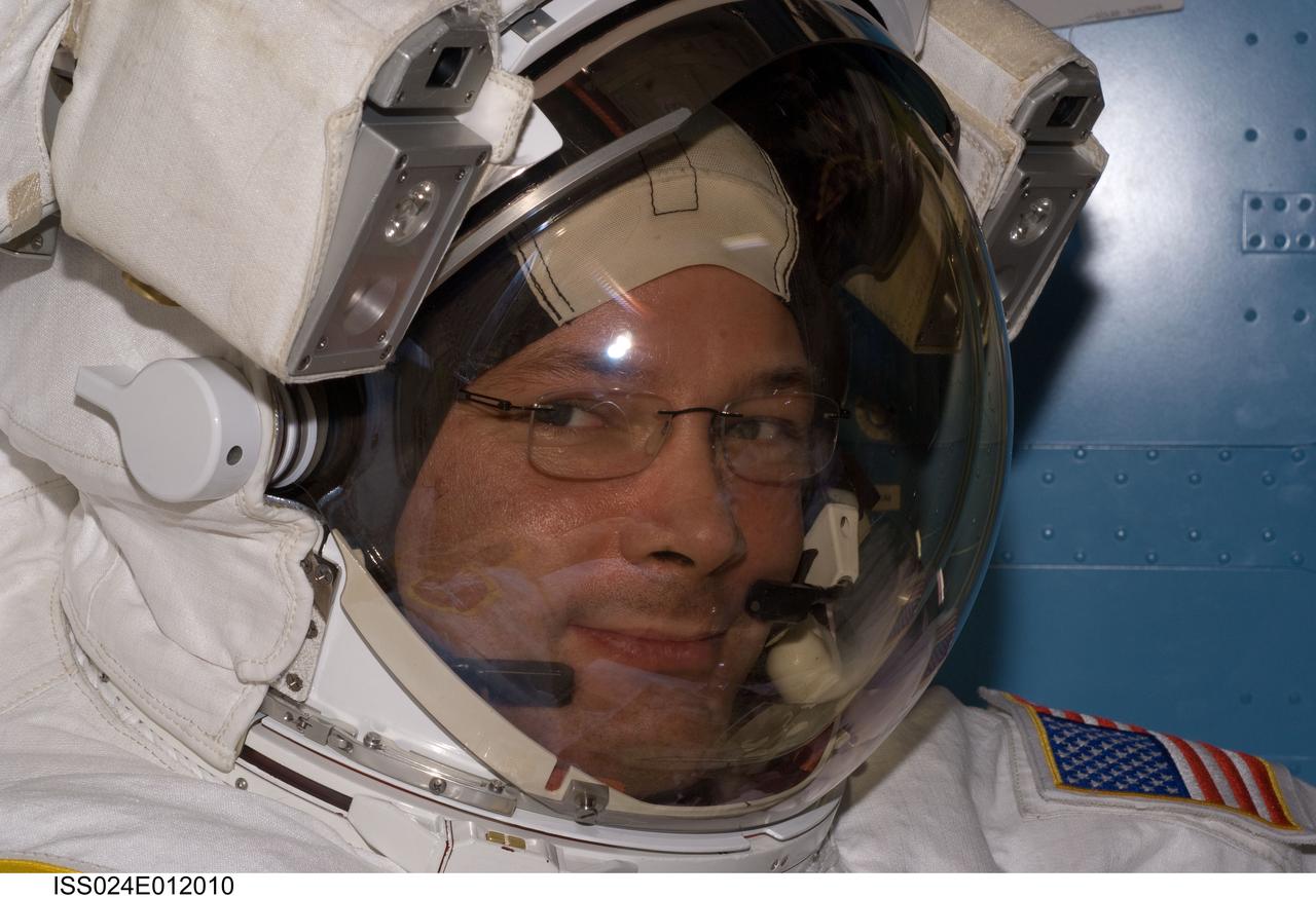 ISS024-E-012010 (16 Aug. 2010) --- NASA astronaut Doug Wheelock, Expedition 24 flight engineer, attired in his Extravehicular Mobility Unit (EMU) spacesuit, is pictured in the Quest airlock of the International Space Station as the final of three planned spacewalks to remove and replace an ammonia pump module that failed July 31 draws to a close.