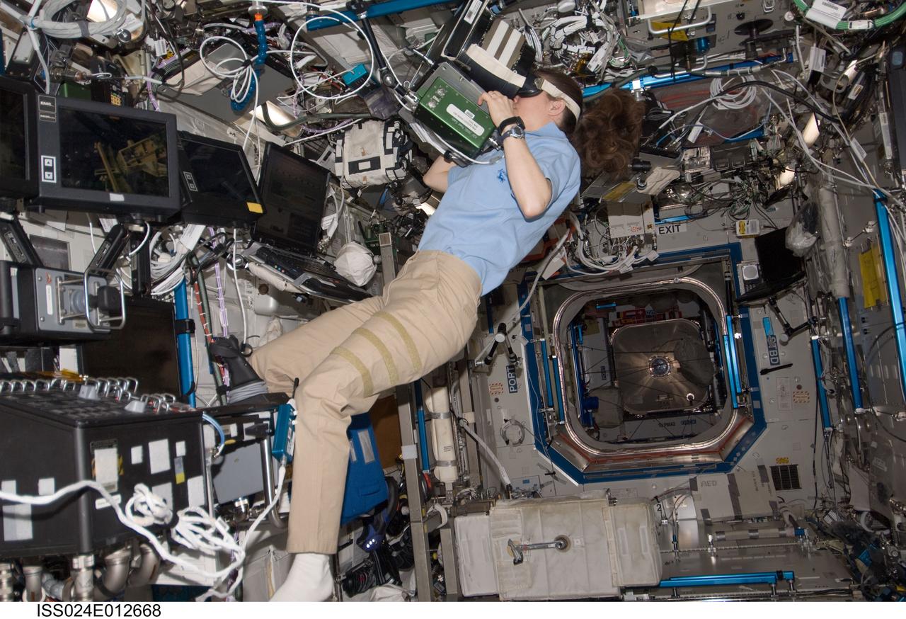ISS024-E-012668 (30 Aug. 2010) --- NASA astronaut Tracy Caldwell Dyson, Expedition 24 flight engineer, uses Neurospat hardware to perform the Bodies in the Space Environment (BISE) experiment in the Destiny laboratory of the International Space Station. The Canadian Space Agency-sponsored BISE experiment studies how astronauts perceive up and down in microgravity.