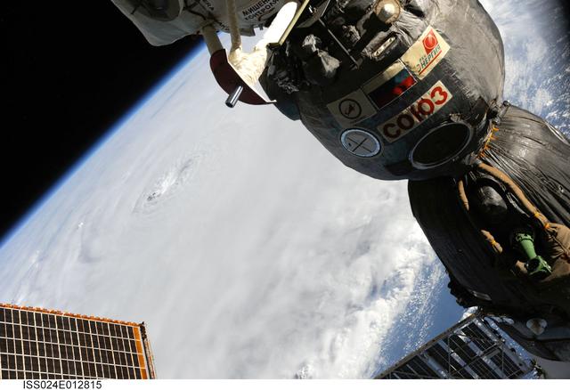 ISS024-E-012815 (30 Aug. 2010) --– Photographed by an Expedition 24 crew member on the International Space Station, this is an oblique view that shows the eye (just left of center) of Hurricane Earl (at this time a category 4 but later downgraded to a category 3), centered just north of the Virgin Islands near 19.3 north latitude and 64.7 west longitude packing 115-kilometer winds. A Russian Soyuz vehicle is docked to the station (foreground). The photo was taken with a digital still camera using a 55mm lens.