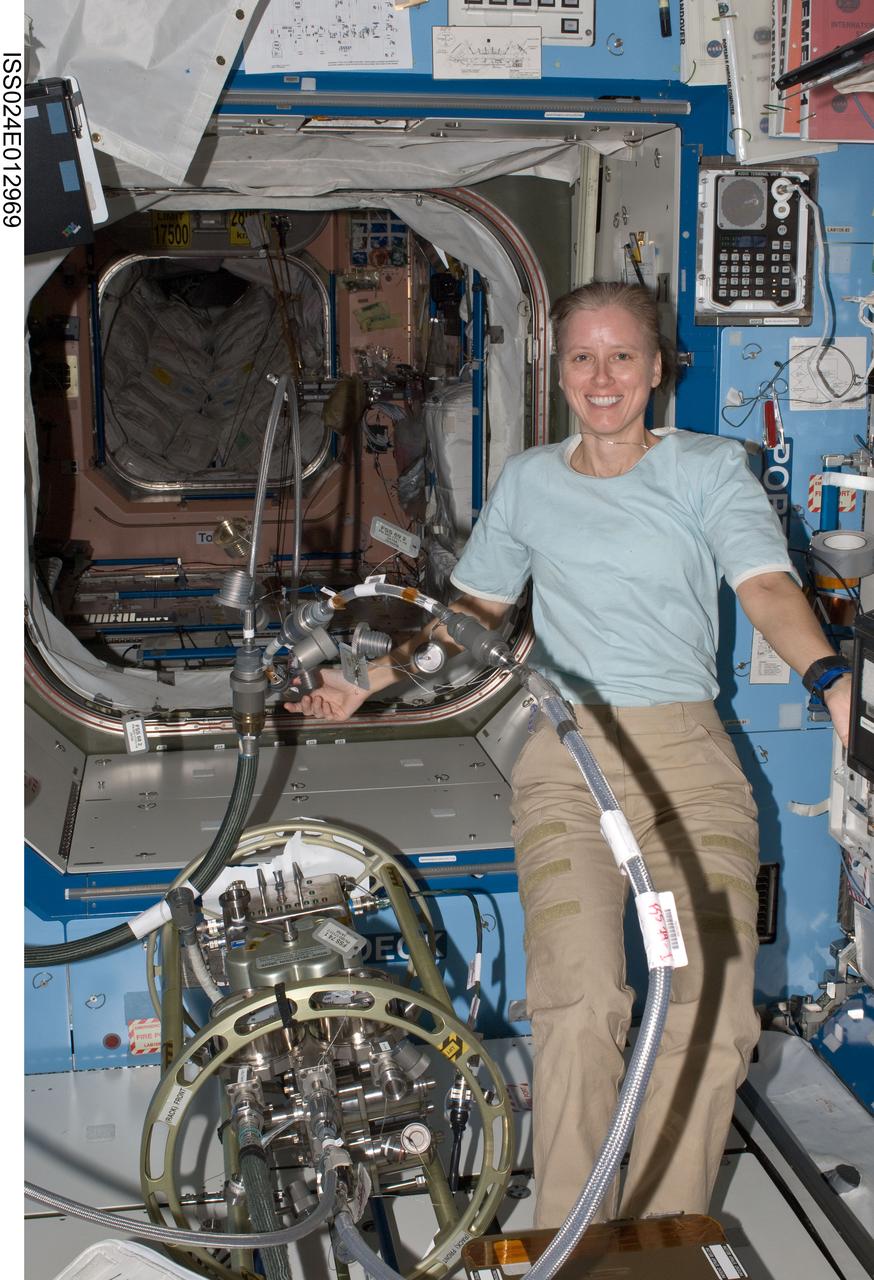 ISS024-E-012969 (31 Aug. 2010) --- NASA astronaut Shannon Walker, Expedition 24 flight engineer, works with the Fluid Servicing System (FSS) in the Destiny laboratory of the International Space Station.