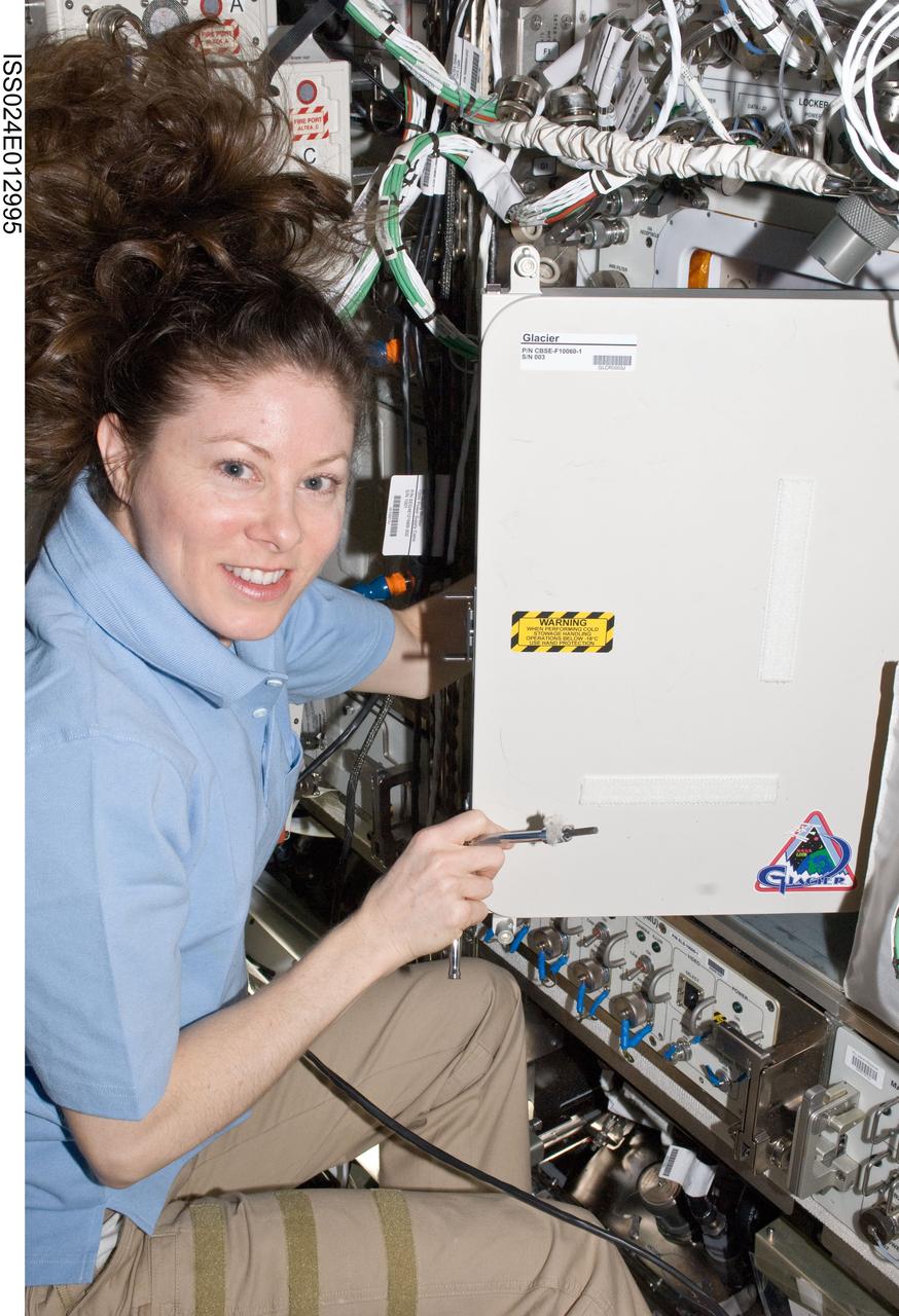 ISS024-E-012995 (1 Sept. 2010) --- NASA astronaut Tracy Caldwell Dyson, Expedition 24 flight engineer, works with the General Laboratory Active Cryogenic ISS Experiment Refrigerator (GLACIER) in the Destiny laboratory of the International Space Station.