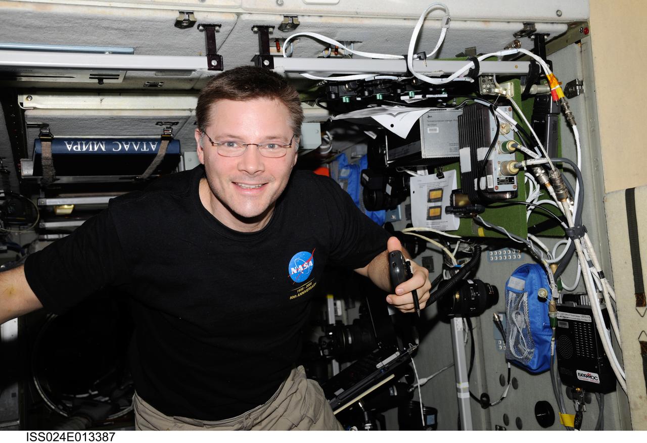 ISS024-E-013387 (5 Sept. 2010) --- NASA astronaut Doug Wheelock, Expedition 24 flight engineer, uses a ham radio system in the Zvezda Service Module of the International Space Station.