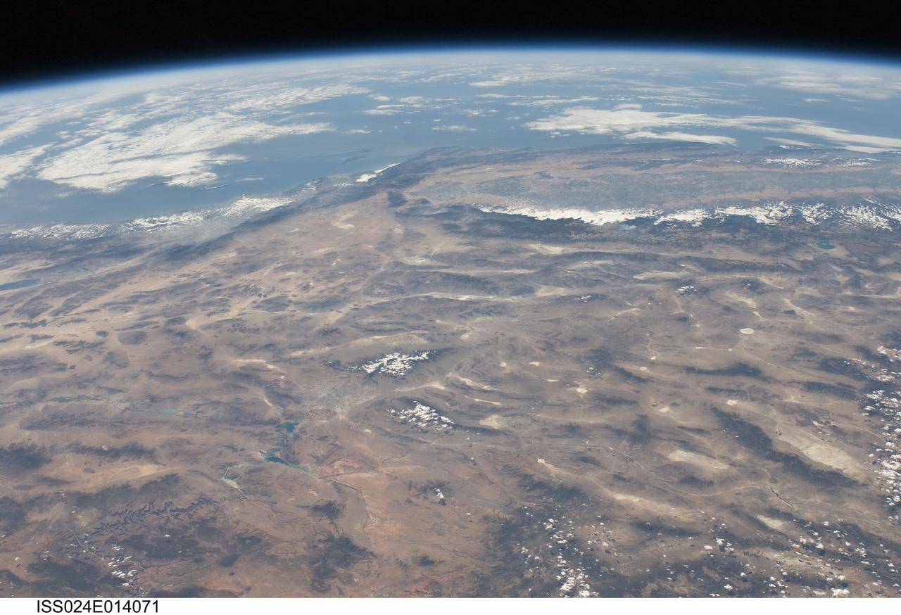 ISS024-E-014071 (9 Sept. 2010) --- This striking panoramic view of the southwestern USA and Pacific Ocean is an oblique image photographed by an Expedition 24 crew member looking outwards at an angle from the International Space Station (ISS). While most unmanned orbital satellites view Earth from a nadir perspective?in other words, collecting data with a ?straight down? viewing geometry?crew members onboard the space station can acquire imagery at a wide range of viewing angles using handheld digital cameras. The ISS nadir point (the point on Earth?s surface directly below the spacecraft) was located in northwestern Arizona, approximately 260 kilometers to the east-southeast, when this image was taken. The image includes parts of the States of Arizona, Nevada, Utah, and California together with a small segment of the Baja California, Mexico coastline at center left. Several landmarks and physiographic features are readily visible. The Las Vegas, NV metropolitan area appears as a gray region adjacent to the Spring Mountains and Sheep Range (both covered by white clouds).  The Grand Canyon, located on the Colorado Plateau in Arizona, is visible (lower left) to the east of Las Vegas with the blue waters of Lake Mead in between. The image also includes the Mojave Desert, stretching north from the Salton Sea (left) to the Sierra Nevada mountain range. The Sierra Nevada range is roughly 640 kilometers long (north-south) and forms the boundary between the Central Valley of California and the adjacent Basin and Range. The Basin and Range is so called due to the pattern of long linear valleys separated by parallel linear mountain ranges ? this landscape, formed by extension and thinning of Earth?s crust, is particularly visible at right.