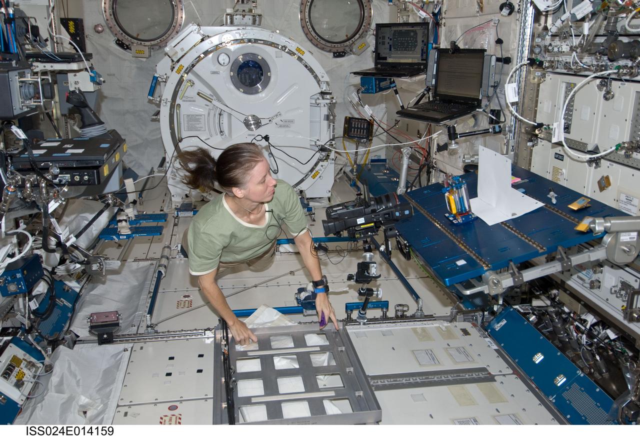 ISS024-E-014159 (9 Sept. 2010) --- NASA astronaut Shannon Walker, Expedition 24 flight engineer, works with the Interior Corner Flow 1 (ICF-1) hardware during video recording of the Capillary Flow Experiment (CFE-1) in the Kibo laboratory of the International Space Station. CFE observes the flow of fluid, in particular capillary phenomena, in microgravity.