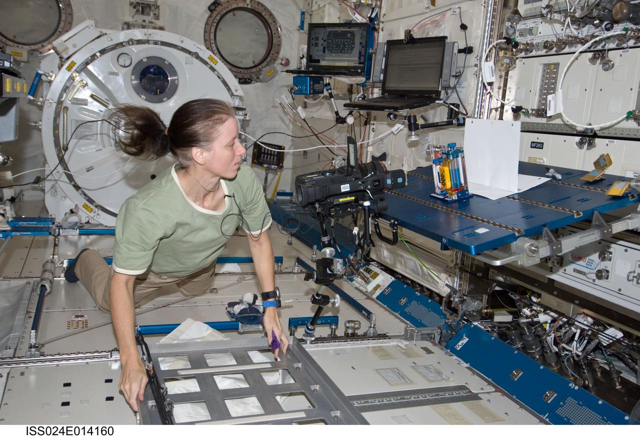 ISS024-E-014160 (9 Sept. 2010) --- NASA astronaut Shannon Walker, Expedition 24 flight engineer, works with the Interior Corner Flow 1 (ICF-1) hardware during video recording of the Capillary Flow Experiment (CFE-1) in the Kibo laboratory of the International Space Station. CFE observes the flow of fluid, in particular capillary phenomena, in microgravity.