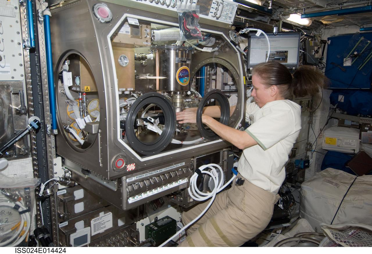 ISS024-E-014424 (13 Sept. 2010) --- NASA astronaut Shannon Walker, Expedition 24 flight engineer, works on the COLLOID experiment inside the Microgravity Science Glovebox (MSG) in the Columbus laboratory of the International Space Station.