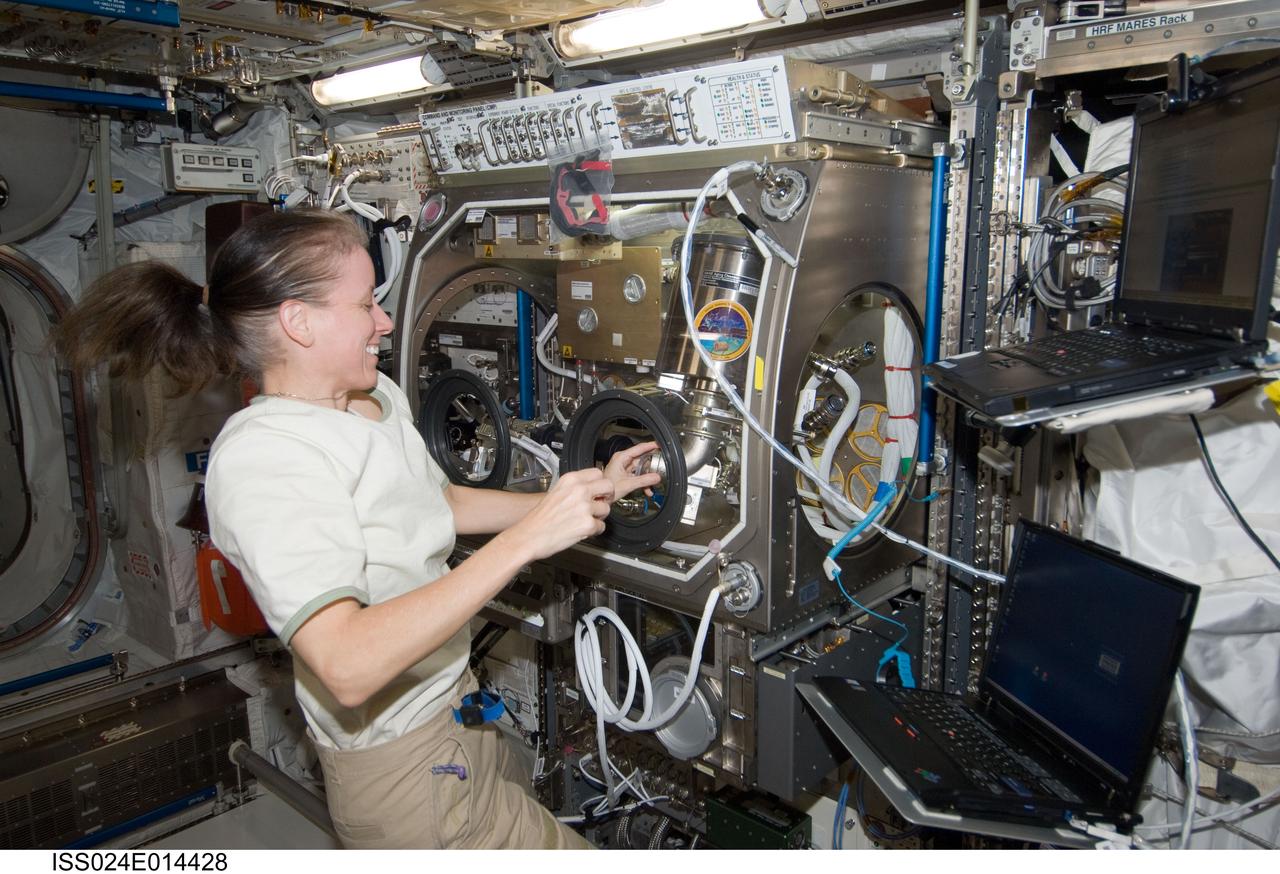 ISS024-E-014428 (13 Sept. 2010) --- NASA astronaut Shannon Walker, Expedition 24 flight engineer, works on the COLLOID experiment inside the Microgravity Science Glovebox (MSG) in the Columbus laboratory of the International Space Station.
