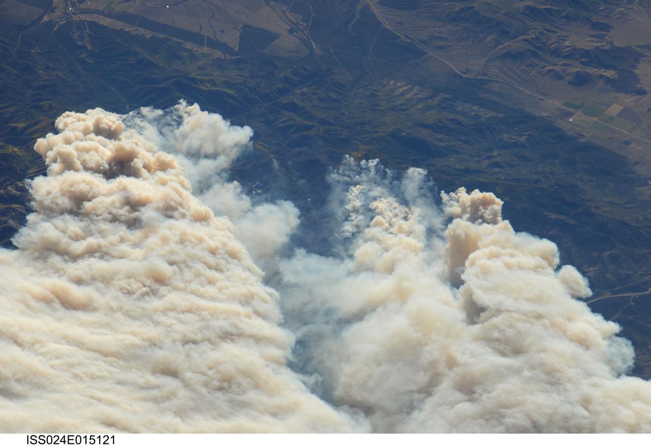 ISS024-E-015121 (20 Sept. 2010) --- Twitchell Canyon Fire in central Utah is featured in this image photographed by an Expedition 24 crew member on the International Space Station (ISS). The Twitchell Canyon Fire near central Utah?s Fishlake National Forest is reported to have an area of approximately 13,383 hectares (approximately 134 square kilometers, or 33,071 acres). This detailed image shows smoke plumes generated by several fire spots close to the southwestern edge of the burned area. The fire was started by a lightning strike on July 20, 2010.  Whereas many of the space station images of Earth are looking straight down (nadir), this photograph was exposed at an angle. The space station was located over a point approximately 509 kilometers (316 miles) to the northeast, near the Colorado/Wyoming border, at the time the image was taken on Sept. 20. Southwesterly winds were continuing to extend smoke plumes from the fire to the northeast. While the Twitchell Canyon region is sparsely populated, Interstate Highway 15 is visible at upper left.