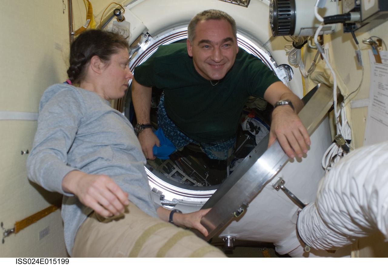 ISS024-E-015199 (23 Sept. 2010) --- Russian cosmonaut Alexander Skvortsov, Expedition 24 commander; and NASA astronaut Tracy Caldwell Dyson, flight engineer, make final preparations for their departure in the Soyuz TMA-18 docked to the Poisk Mini-Research Module 2 (MRM2) of the International Space Station. The Soyuz undocked at 10:02 p.m. (EDT) on Sept. 24, 2010, carrying Skvortsov and Caldwell Dyson, along with Russian cosmonaut Mikhail Kornienko (out of frame). Originally scheduled for Sept. 23, the Soyuz undocked a day later due to a Poisk-side hatch sensor problem, which prevented hooks on the Poisk side of the docking interface from opening.