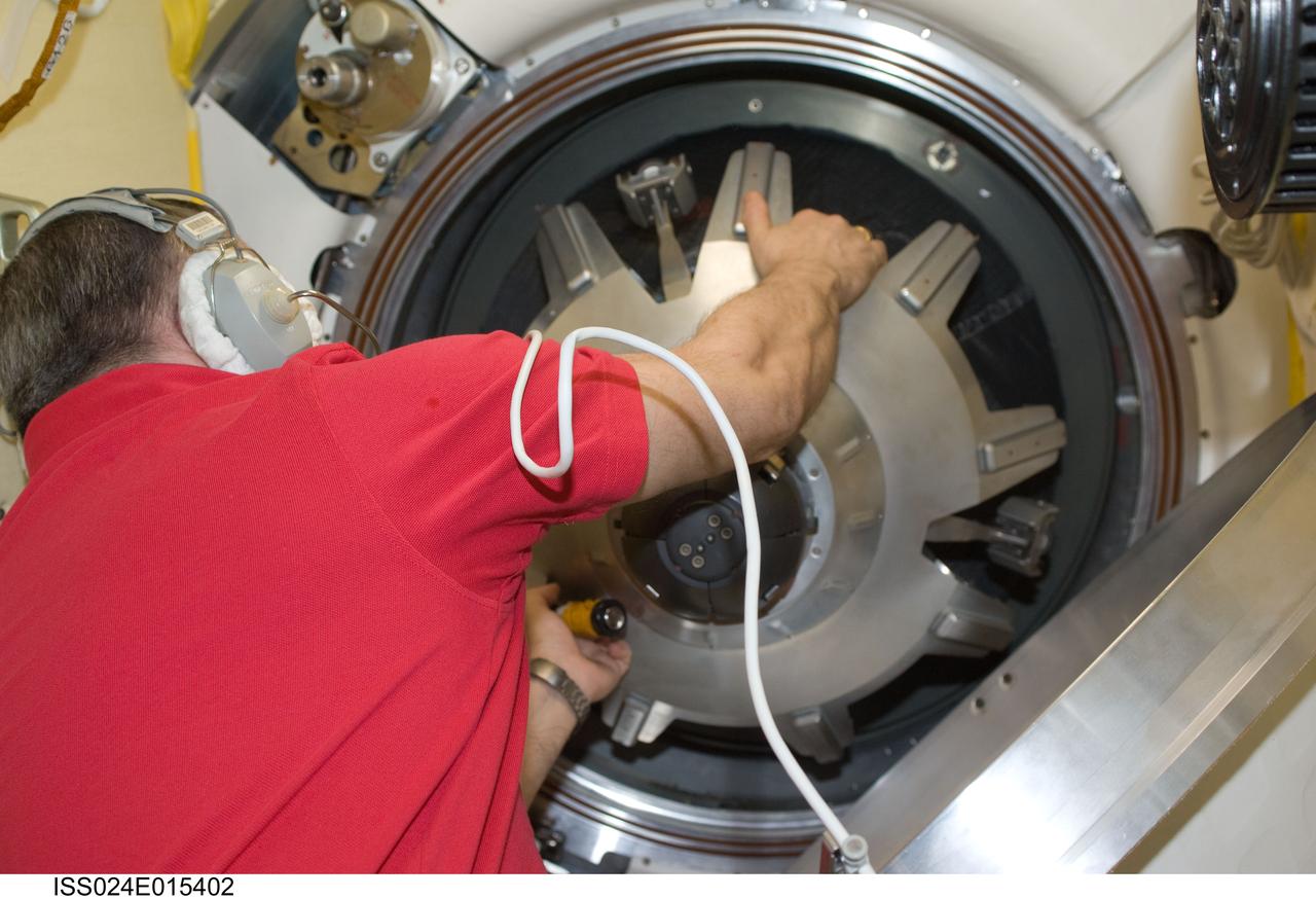 ISS024-E-015402 (24 Sept. 2010) --- Russian cosmonaut Fyodor Yurchikhin, Expedition 24/25 flight engineer, closes the hatch between the International Space Station and the Soyuz TMA-18 spacecraft as three Expedition 24 crew members prepare to depart from the space station. Undocking occurred at 10:02 p.m. (EDT) on Sept. 24, 2010, carrying Russian cosmonaut Alexander Skvortsov, Soyuz commander and Expedition 24 commander; along with NASA astronaut Tracy Caldwell Dyson and Russian cosmonaut Mikhail Kornienko, both flight engineers. Originally scheduled for Sept. 23, the Soyuz undocked a day later due to a Poisk-side hatch sensor problem, which prevented hooks on the Poisk side of the docking interface from opening.