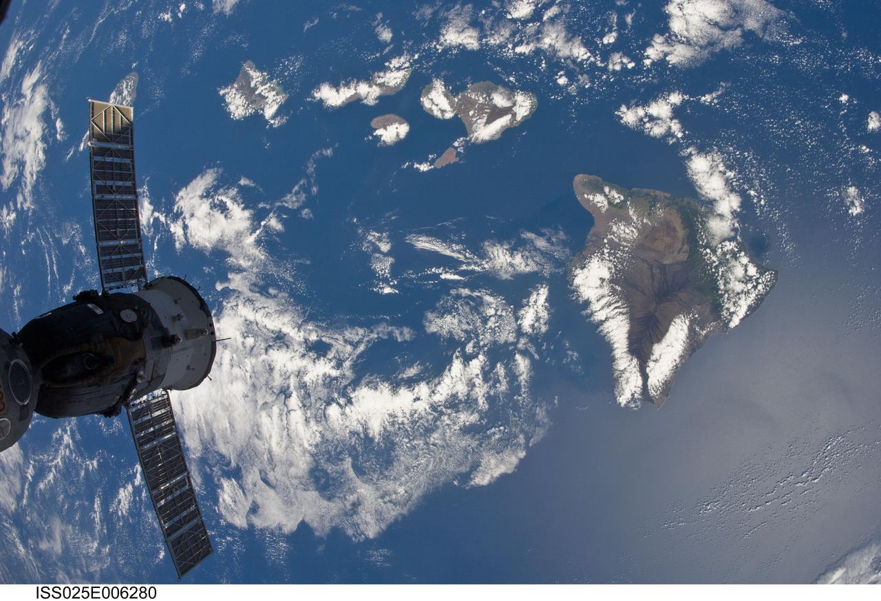 ISS025-E-006280 (7 Oct. 2010) ---  While on an orbit that took the International Space Station over the Pacific Ocean, one of the Expedition 25 crew members captured this image of part of the Hawaiian Island chain.  While most of the islands are either out of frame or covered by clouds, Hawaii, the largest of them, is visible at right. A Russian Soyuz, docked to the orbital outpost,  is in left foreground.