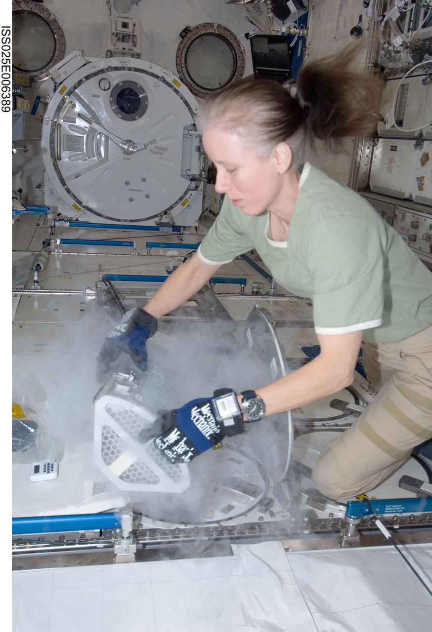 ISS025-E-006389 (8 Oct. 2010) --- NASA astronaut Shannon Walker, Expedition 25 flight engineer, services the Minus Eighty Laboratory Freezer for ISS (MELFI-1) in the Kibo laboratory of the International Space Station.