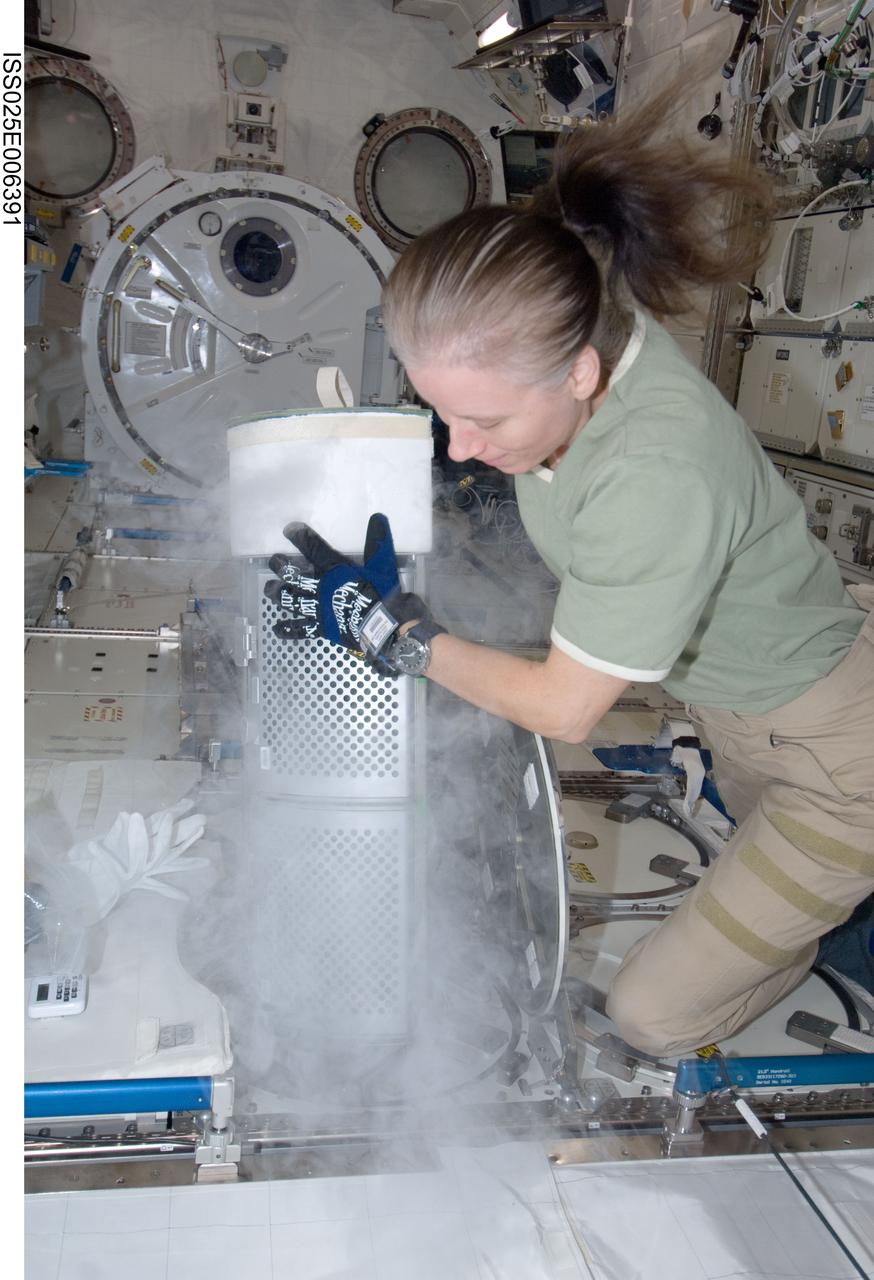 ISS025-E-006391 (8 Oct. 2010) --- NASA astronaut Shannon Walker, Expedition 25 flight engineer, services the Minus Eighty Laboratory Freezer for ISS (MELFI-1) in the Kibo laboratory of the International Space Station.