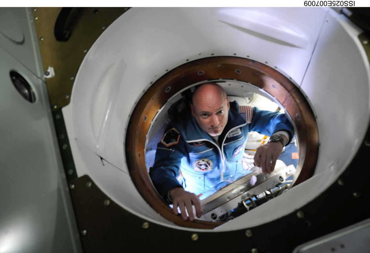 ISS025-E-007009 (9 Oct. 2010) --- NASA astronaut Scott Kelly, Expedition 25 flight engineer, is pictured inside the hatch area of the Soyuz TMA-01M spacecraft on docking day with the International Space Station.