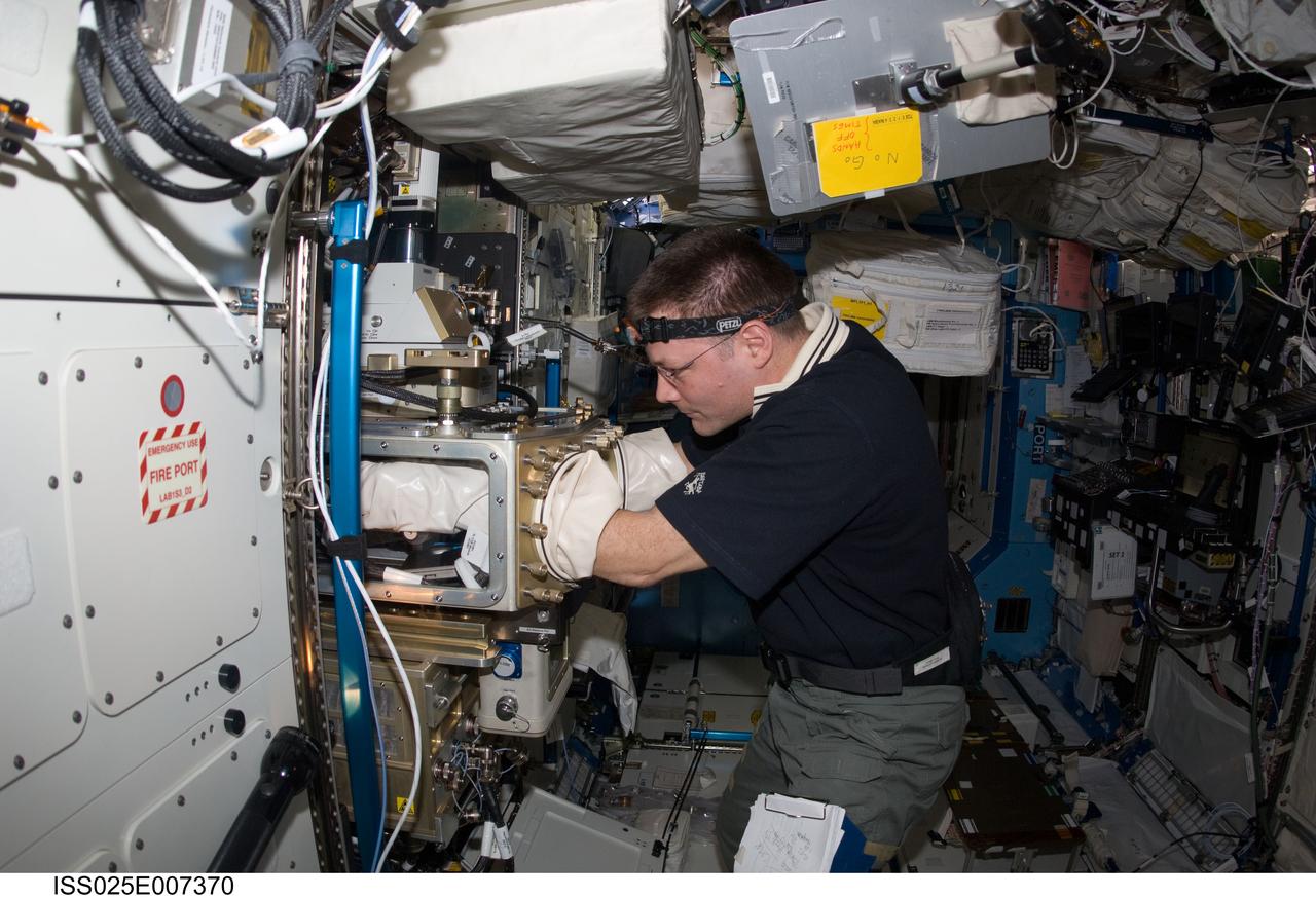 ISS025-E-007370 (14 Oct. 2010) --- NASA astronaut Doug Wheelock, Expedition 25 commander, works in a glovebox in the Destiny laboratory of the International Space Station.