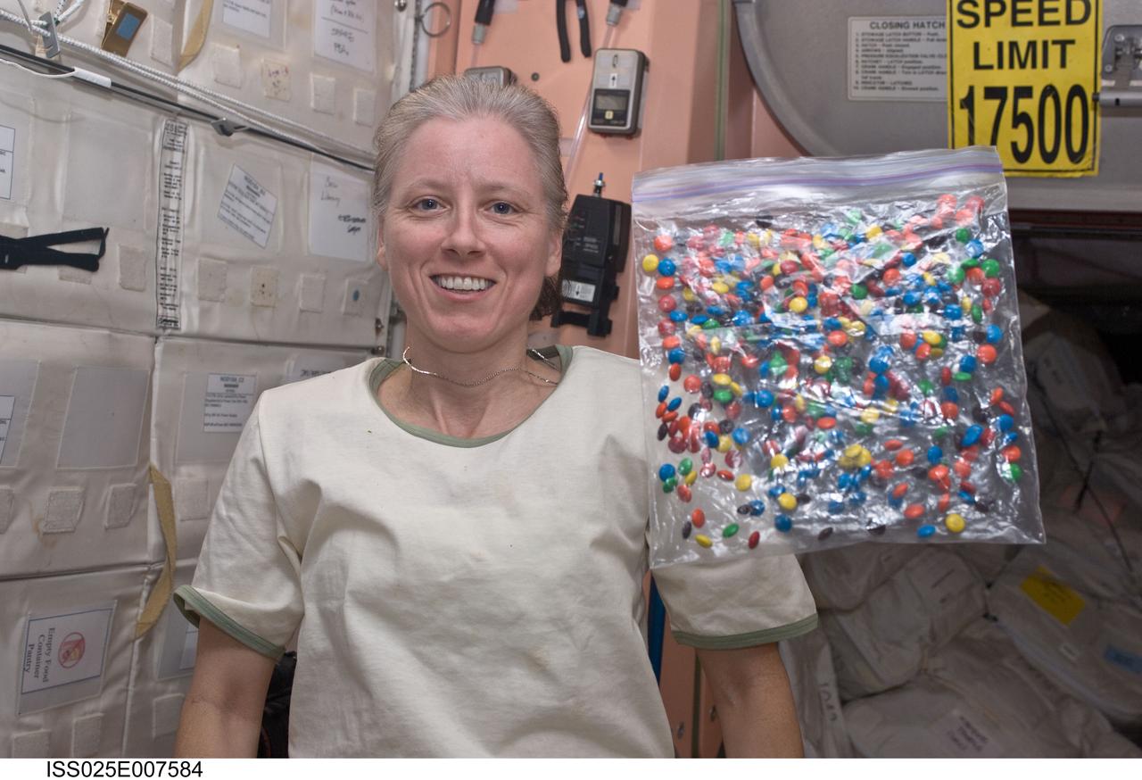 ISS025-E-007584 (17 Oct. 2010) --- NASA astronaut Shannon Walker, Expedition 25 flight engineer, is pictured with a bag of candy floating freely in the Unity node of the International Space Station.