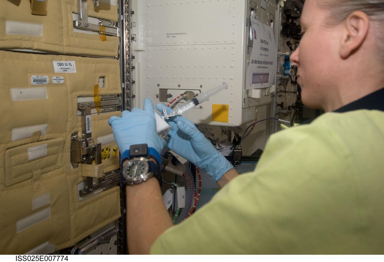 ISS025-E-007774 (18 Oct. 2010) --- NASA astronaut Shannon Walker, Expedition 25 flight engineer, works with the Japan Aerospace Exploration Agency (JAXA) experiment HydroTropi (Hydrotropism & Auxin-Inducible Gene Expression in Roots Grown under Microgravity Conditions) in the Kibo laboratory of the International Space Station.