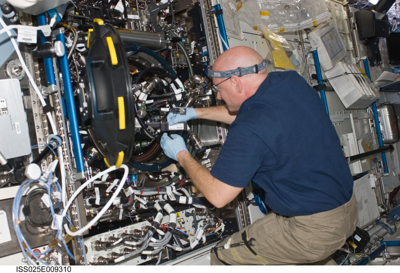 ISS025-E-009310 (26 Oct. 2010) --- NASA astronaut Scott Kelly, Expedition 25 flight engineer, works on the Combustion Integrated Rack (CIR) Multi-user Drop Combustion Apparatus (MDCA) in the Destiny laboratory of the International Space Station. Kelly set up an experiment run on the Fluids & Combustion Facility (FCF) with a new fuel reservoir, ground-assisted by Payload Operations Integration Center/Huntsville (POIC).
