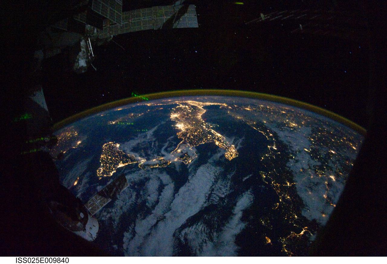 ISS025-E-009840 (28 Oct. 2010) --- Parts of Europe and Africa are very easily recognizable in this night time image shot by one of the Expedition 25 crew members aboard the International Space Station flying 220 miles above Earth on Oct. 28. The view "looks" northward over Sicily and the "boot" of Italy, with the Mediterranean Sea representing most of the visible water in the view and the Adriatic Sea to the right of center. Tunisia is partially visible at left. Part of a docked Russian spacecraft and other components of the ISS are in the foreground.