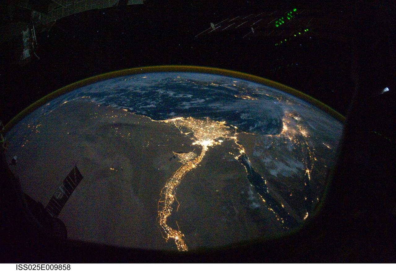 ISS025-E-009858 (28 Oct. 2010) --- From 220 miles above Earth, one of the Expedition 25 crew members on the International Space Station took this night time photo featuring the bright lights of Cairo and Alexandria, Egypt on the Mediterranean coast.  The Nile River and its delta stand out clearly as well. On the horizon, the airglow of the atmosphere is seen across the Mediterranean. The Sinai Peninsula, at right, is outlined with lights highlighting the Gulf of Suez and Gulf of Aqaba.
