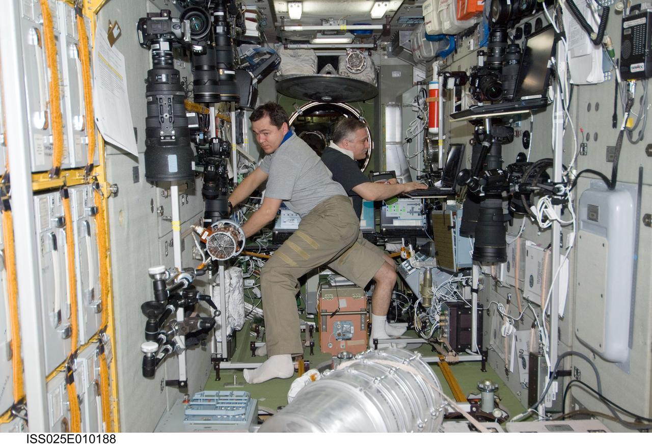 ISS025-E-010188 (31 Oct. 2010) --- Russian cosmonauts Oleg Skripochka (foreground) and Fyodor Yurchikhin, both Expedition 25 flight engineers, work in the Zvezda Service Module of the International Space Station.