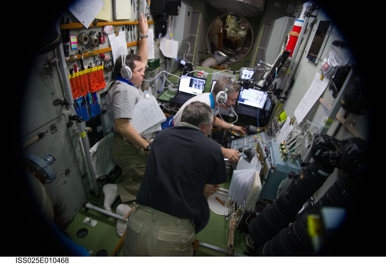 ISS025-E-010468 (30 Oct. 2010) --- Russian cosmonauts Alexander Kaleri (right background), Fyodor Yurchikhin (foreground) and Oleg Skripochka, all Expedition 25 flight engineers, monitor data at the manual TORU docking system controls in the Zvezda Service Module of the International Space Station during the docking operations of the unpiloted ISS Progress 40 resupply vehicle. Progress 40 docked to the Pirs Docking Compartment at 12:36 p.m. (EDT) on Oct. 30, 2010, after Kaleri took over manual control to guide the Progress to its final connection.