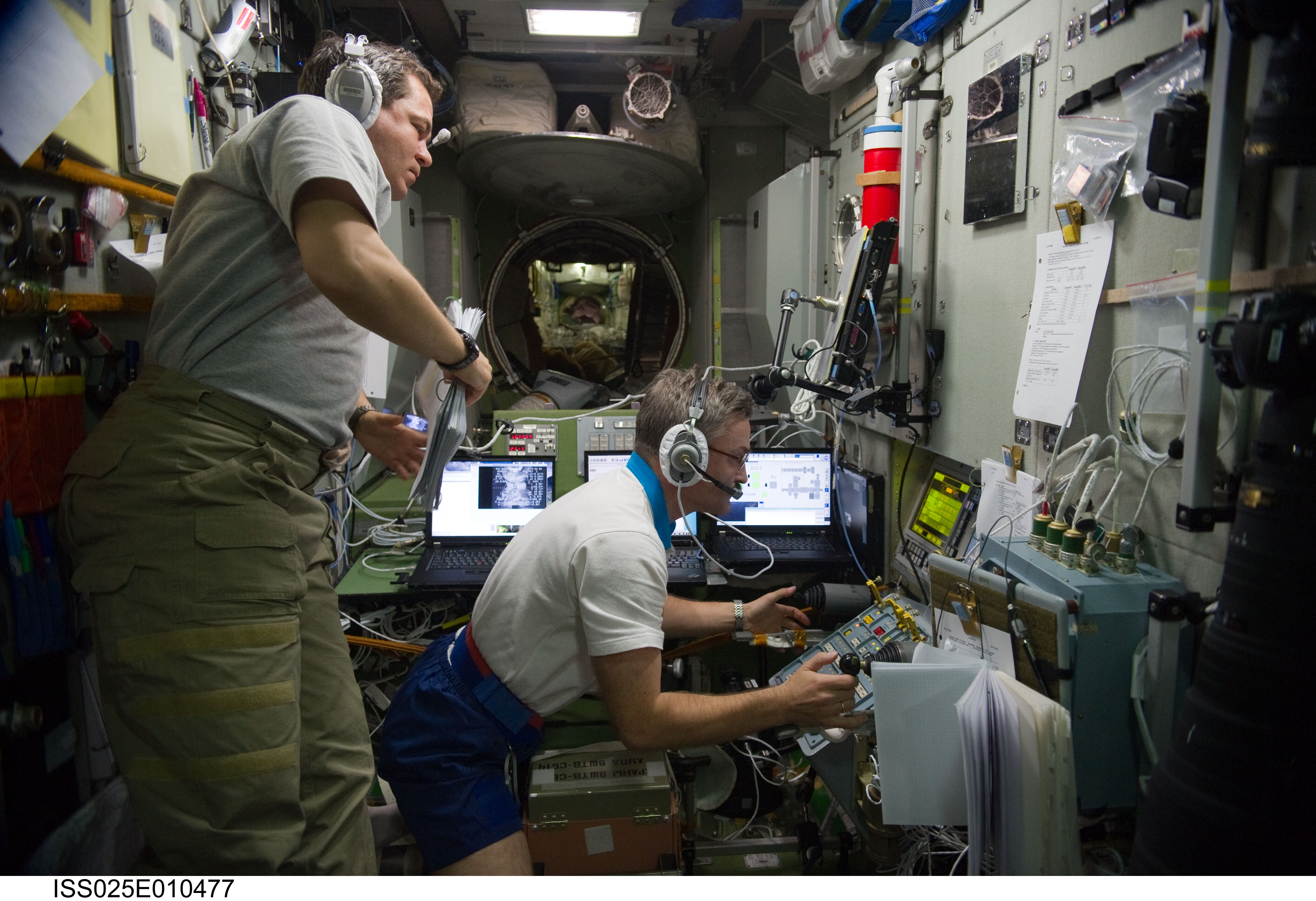 ISS025-E-010477 (30 Oct. 2010) --- Russian cosmonauts Alexander Kaleri (right) and Oleg Skripochka, both Expedition 25 flight engineers, monitor data at the manual TORU docking system controls in the Zvezda Service Module of the International Space Station during the docking operations of the unpiloted ISS Progress 40 resupply vehicle. Progress 40 docked to the Pirs Docking Compartment at 12:36 p.m. (EDT) on Oct. 30, 2010, after Kaleri took over manual control to guide the Progress to its final connection.