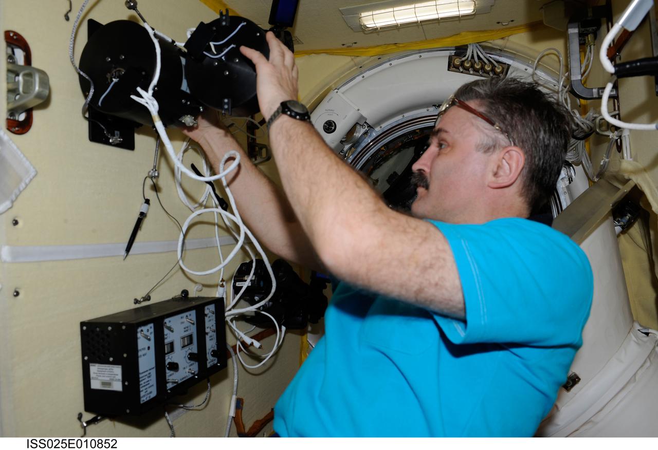 ISS025-E-010852 (3 Nov. 2010) --- Russian cosmonaut Alexander Kaleri, Expedition 25 flight engineer, works on the newly installed Russian experiment KPT-10 "Kulonovskiy Kristall" (Coulomb Crystal), assembling the payload equipment and initiating operation, in a Russian module on the International Space Station.