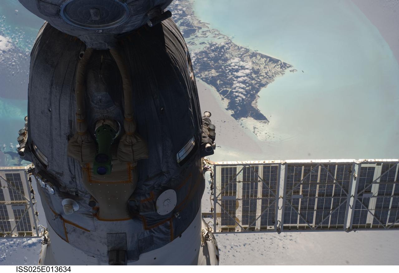 ISS025-E-013634 (9 Nov. 2010) --- The Soyuz TMA-19 spacecraft dominates the foreground of this image exposed by one of the Expedition 25 crew members as the International Space Station and the docked Russian spacecraft were 220 miles above the Caribbean Sea.  The island of Andros, in the Bahamas chain, can be seen in the background. Three members of the current six-person staffing aboard the orbital complex are expected to return to Earth in the Soyuz in about two and half weeks.