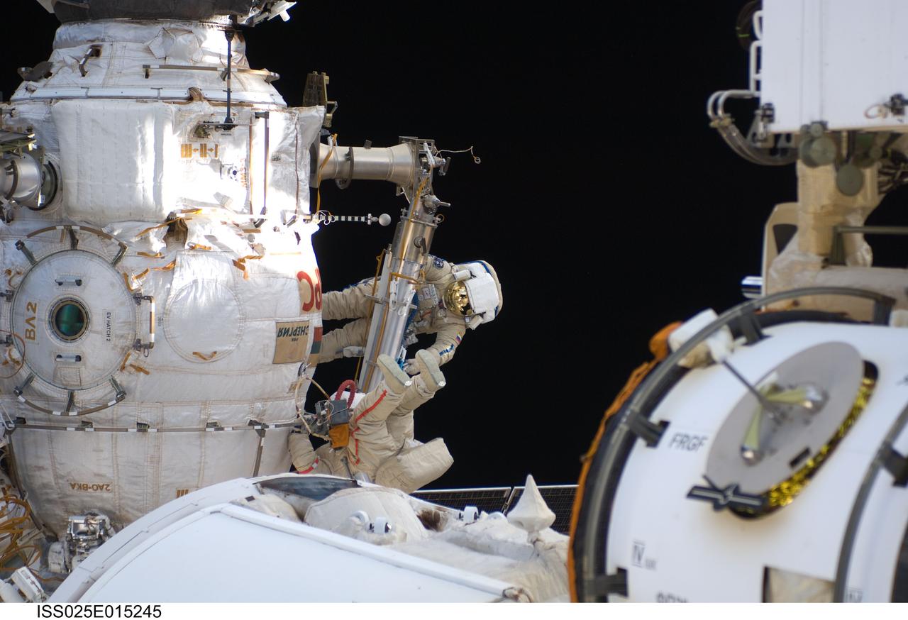 ISS025-E-015245 (15 Nov. 2010) --- Russian cosmonauts Oleg Skripochka (top) and Fyodor Yurchikhin, both Expedition 25 flight engineers, wearing Russian Orlan spacesuits, participate in a session of extravehicular activity (EVA) as construction and maintenance continue on the International Space Station. During the six-hour, 27-minute spacewalk, Skripochka and Yurchikhin installed a multipurpose workstation on the starboard side of the Zvezda Service Module’s large-diameter section and relocated a television camera from one end of the Rassvet docking compartment to the other.