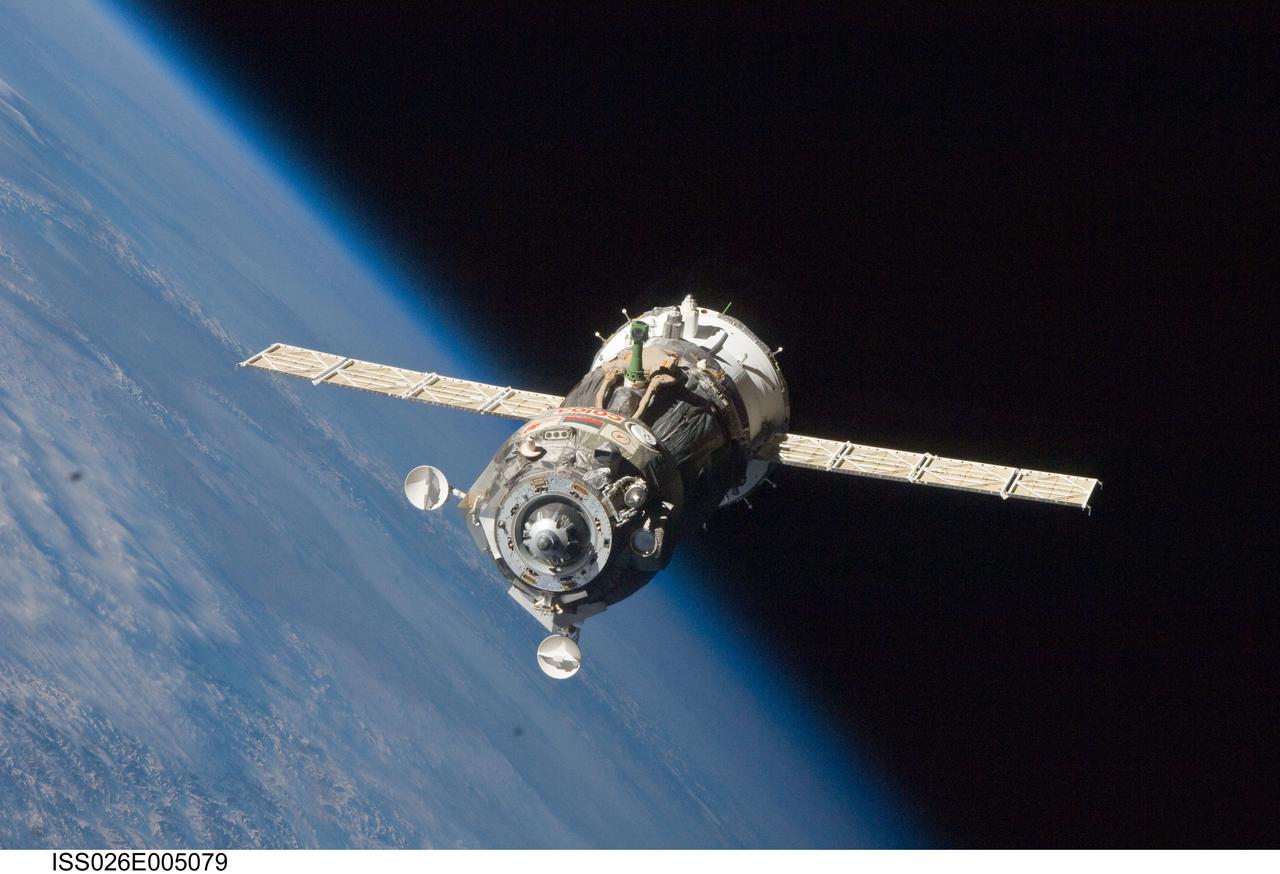 ISS026-E-005079 (25 Nov. 2010) --- The Soyuz TMA-19 spacecraft departs the International Space Station on Nov. 25, 2010. Onboard are three members of Expedition 25 – NASA astronaut Doug Wheelock, commander; along with NASA astronaut Shannon Walker and Russian cosmonaut Fyodor Yurchikhin, both flight engineers. Yurchikhin, the Soyuz commander, was at the controls of the spacecraft as it undocked at 8:23 p.m. (EST) from the station's Rassvet module. The blackness of space and Earth’s horizon provide the backdrop for the scene.