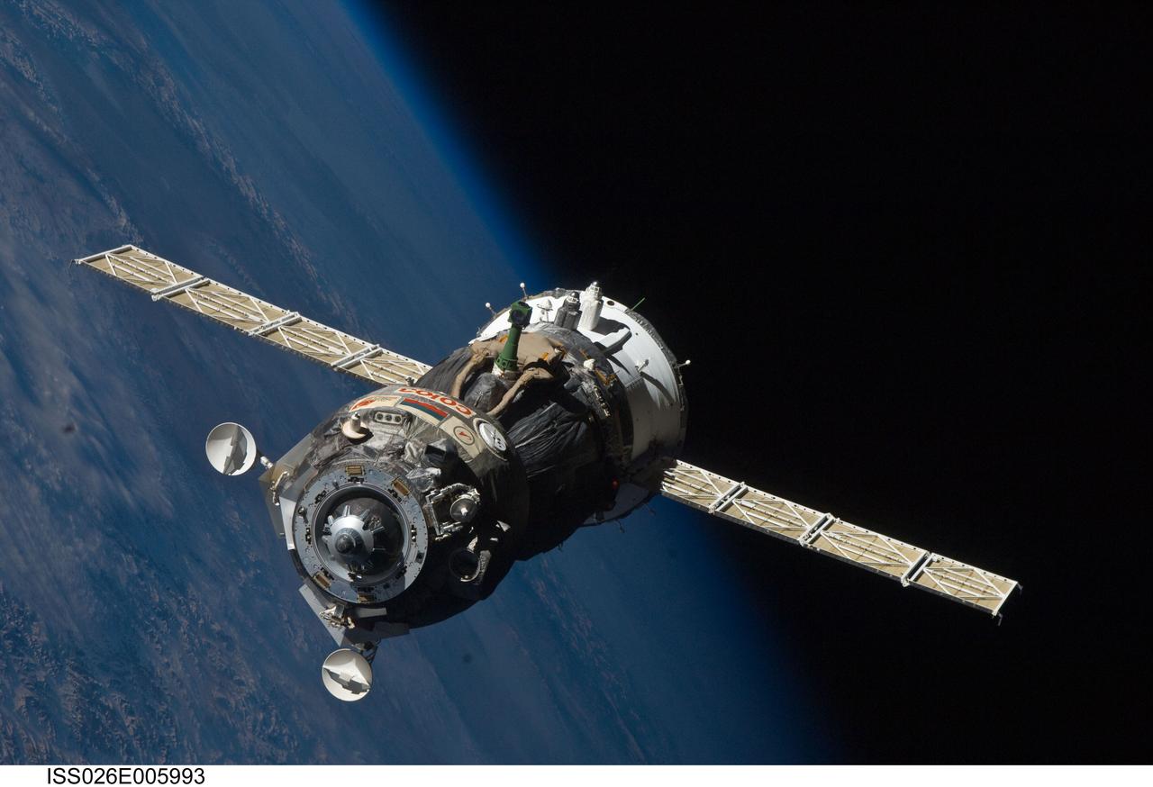 ISS026-E-005993 (25 Nov. 2010) --- The Soyuz TMA-19 spacecraft departs the International Space Station on Nov. 25, 2010. Onboard are three members of Expedition 25 – NASA astronaut Doug Wheelock, commander; along with NASA astronaut Shannon Walker and Russian cosmonaut Fyodor Yurchikhin, both flight engineers. Yurchikhin, the Soyuz commander, was at the controls of the spacecraft as it undocked at 8:23 p.m. (EST) from the station's Rassvet module. The blackness of space and Earth’s horizon provide the backdrop for the scene.