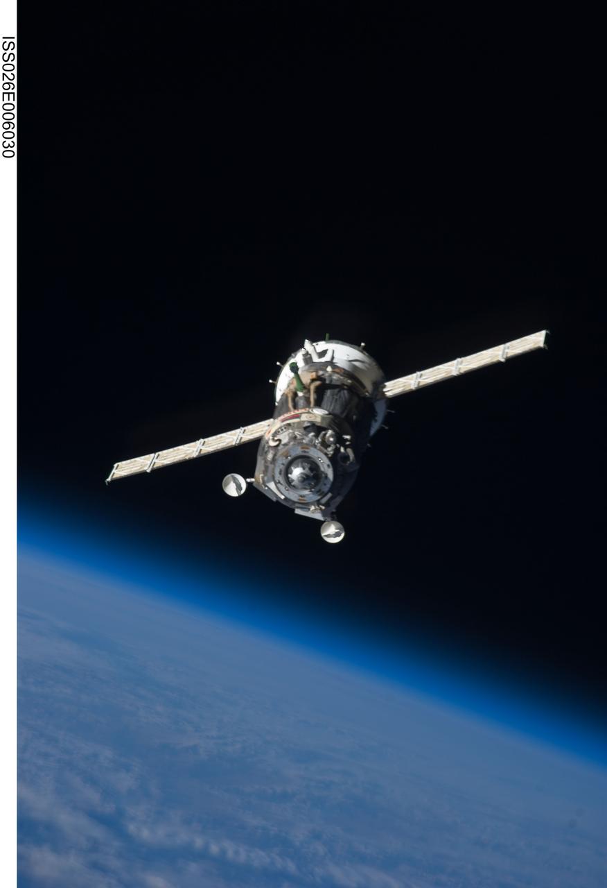 ISS026-E-006030 (25 Nov. 2010) --- The Soyuz TMA-19 spacecraft departs the International Space Station on Nov. 25, 2010. Onboard are three members of Expedition 25 – NASA astronaut Doug Wheelock, commander; along with NASA astronaut Shannon Walker and Russian cosmonaut Fyodor Yurchikhin, both flight engineers. Yurchikhin, the Soyuz commander, was at the controls of the spacecraft as it undocked at 8:23 p.m. (EST) from the station's Rassvet module. The blackness of space and Earth’s horizon provide the backdrop for the scene.