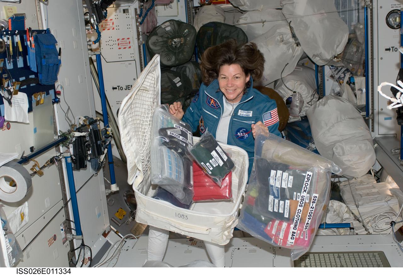 ISS026-E-011334 (18 Dec. 2010) --- NASA astronaut Catherine (Cady) Coleman, Expedition 26 flight engineer, is pictured with a stowage container and its contents in the Harmony node of the International Space Station.