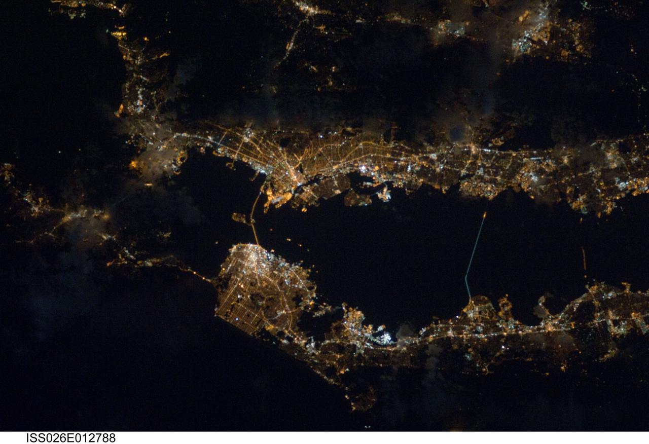 ISS026-E-012788 (26 Dec. 2010) --- Though dark clouds limit the visibility of much of the eastern side (top of frame) of California's Bay Area, lights expose most of the region's highly populated areas. From 220 miles above Earth, the photo was recorded with a still camera equipped with a 180-mm lens on Dec. 26 by one of the crew members onboard the Earth-orbiting International Space Station.