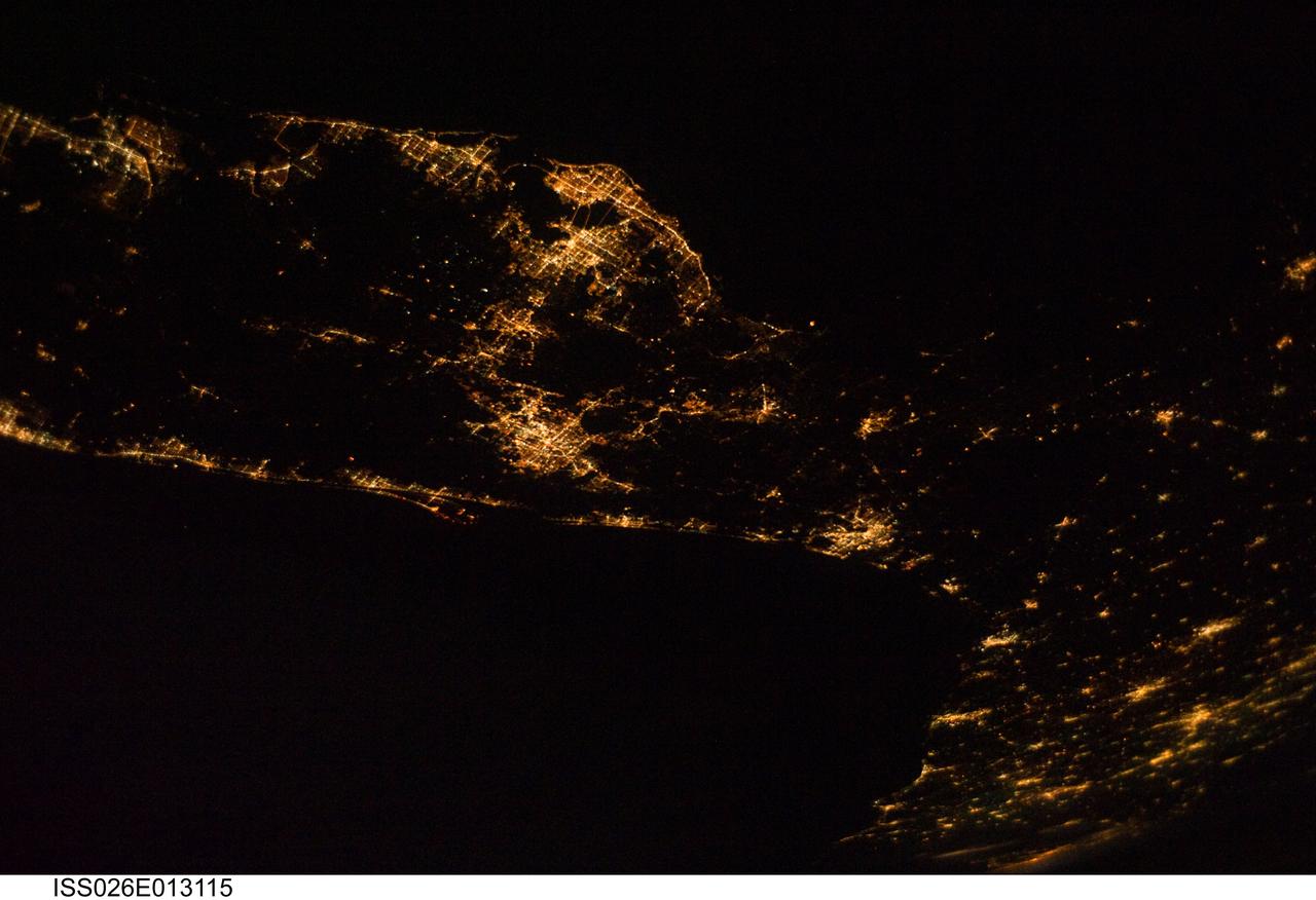 ISS026-E-013115 (28 Dec. 2010) --- From 220 miles above Earth, one of the Expedition 26 crew members used a 32-mm lens to capture this night time image of much of the Florida peninsula. The picture needs to be rotated 90 degrees counter-clockwise to situate north at the top. St. Petersburg, Tampa Bay and Fort Myers can be easily delineated on the Gulf of Mexico (top in the original orientation) side and the spread-out bright lights of the Orlando area appear near frame center. Cape Canaveral and the Kennedy Space Center can also be spotted on the Atlantic side of Florida, with lights of Jacksonville visible further northward.