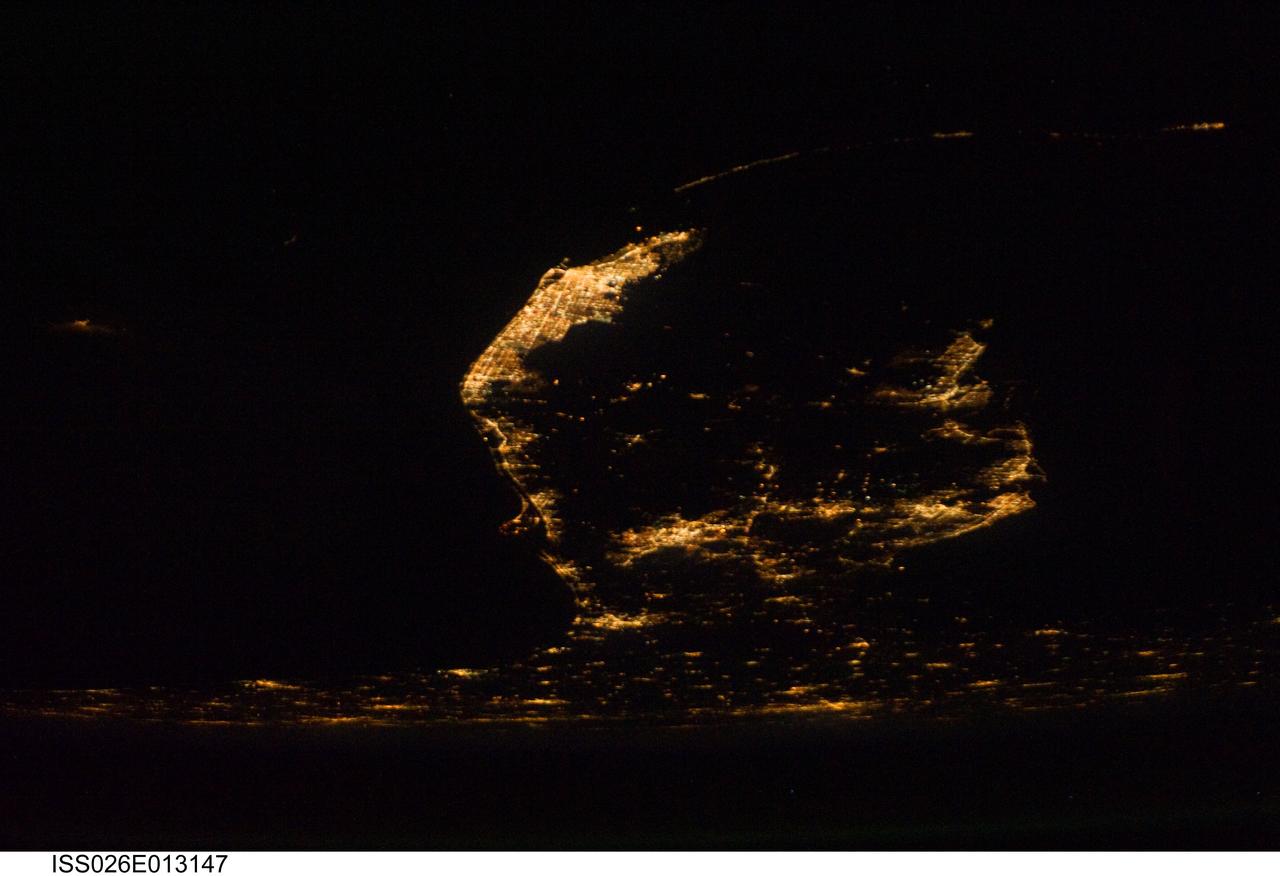ISS026-E-013147 (28 Dec. 2010) --- A southerly looking night view of the upper two thirds of the Florida peninsula was recorded by one of the Expedition 26 crew members aboard the International Space Station on Dec. 28, 2010. Cape Canaveral and the Kennedy Space Center are very well lighted on the left (Atlantic Ocean) side of the peninsula. The Tampa-St. Petersburg area is seen on the Gulf of Mexico or right side of the frame. At bottom or in the north areas of the picture are portions of the state?s panhandle as well as cities and communities in southern Georgia.